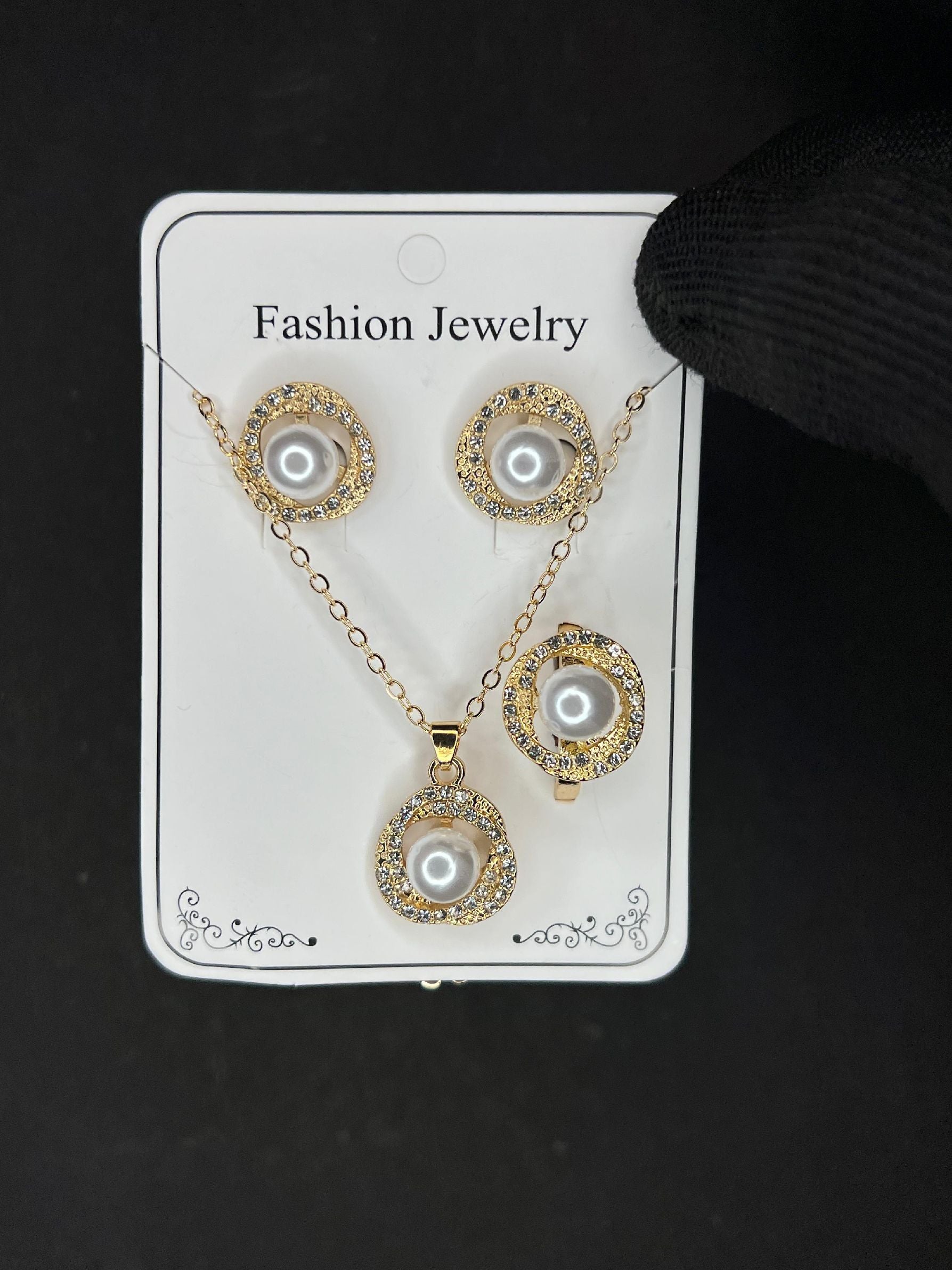 Pearl and crystal fashion jewelry set with necklace, earrings, and ring displayed on card