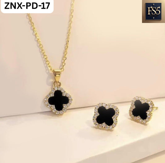 Gold-tone necklace and stud earrings set with black clover-shaped pendants surrounded by clear stones