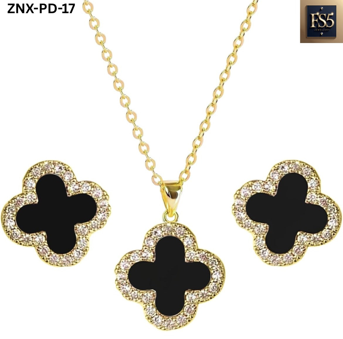 Close-up front view of matching black clover necklace and stud earrings with gold settings