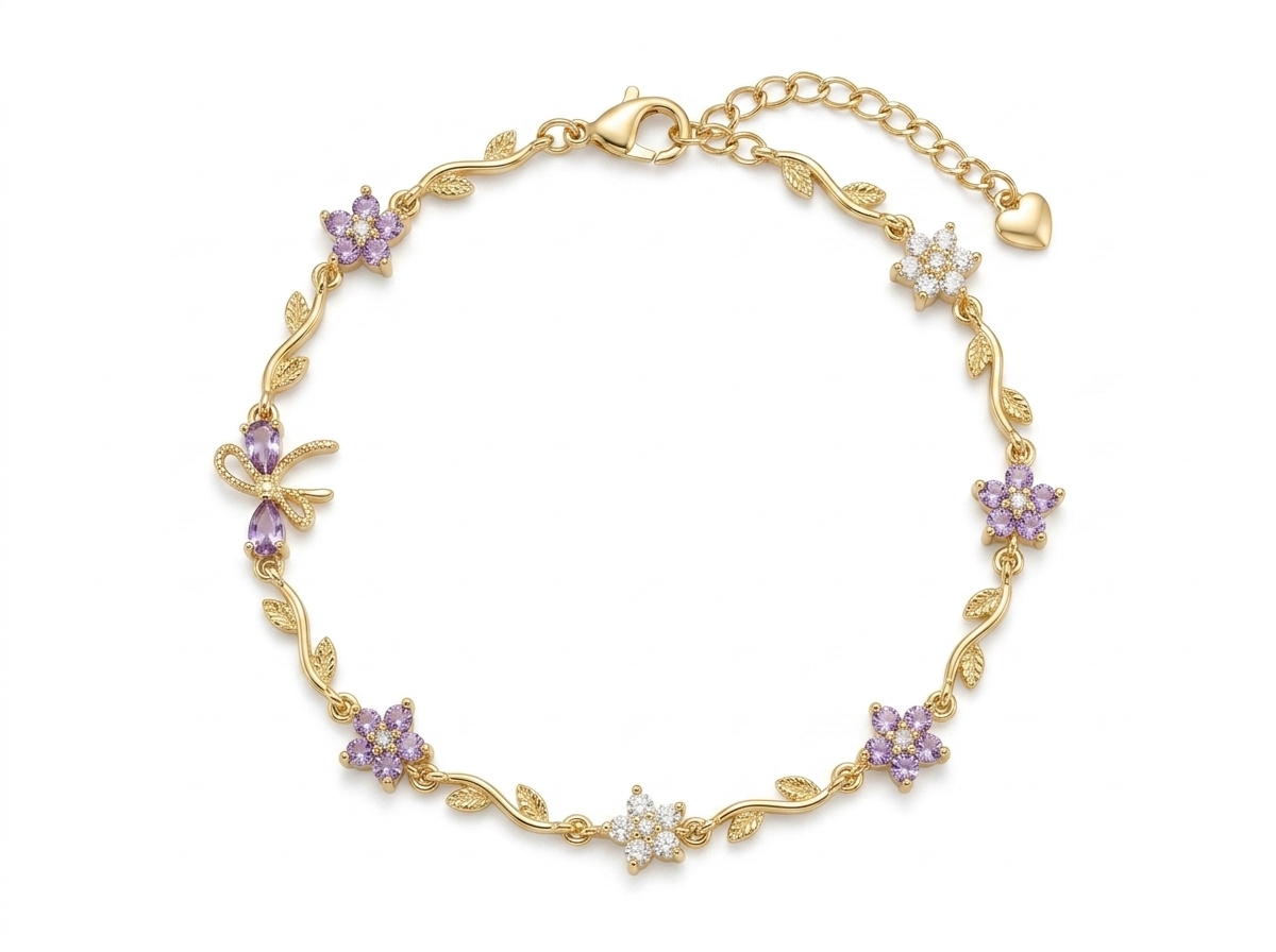 Gold floral bracelet laid flat, showing alternating purple and white flower charms and leaf accents with adjustable chain